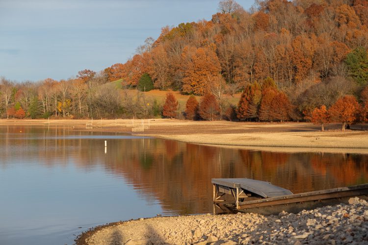 Normandy Lake in Coffee County, TN. Autumn tree colors are reflected from the glassy water of the lake in a cove