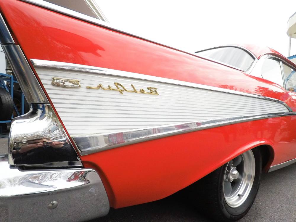 Close up shot of the rear fin on a cherry red 1957 Chevy hotrod